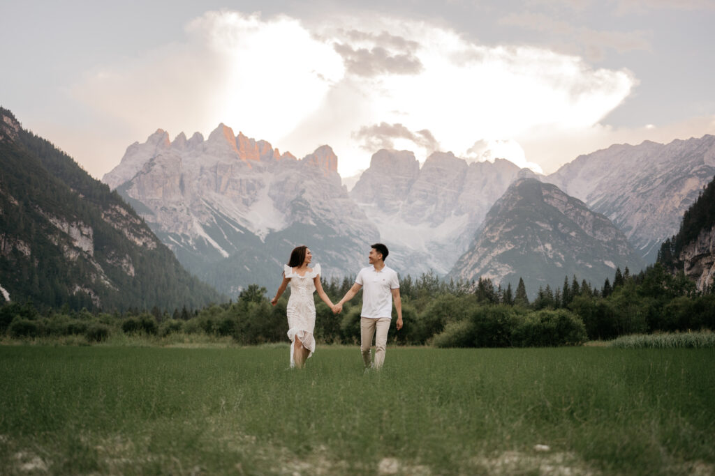 Couple holding hands in mountain landscape