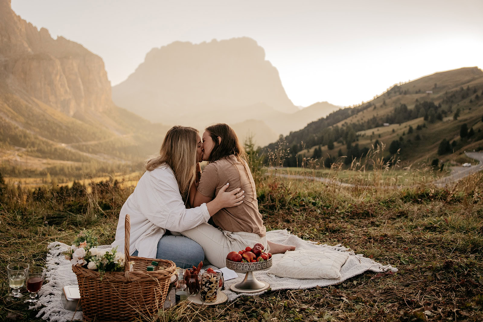 Couple enjoying romantic picnic in mountain setting.