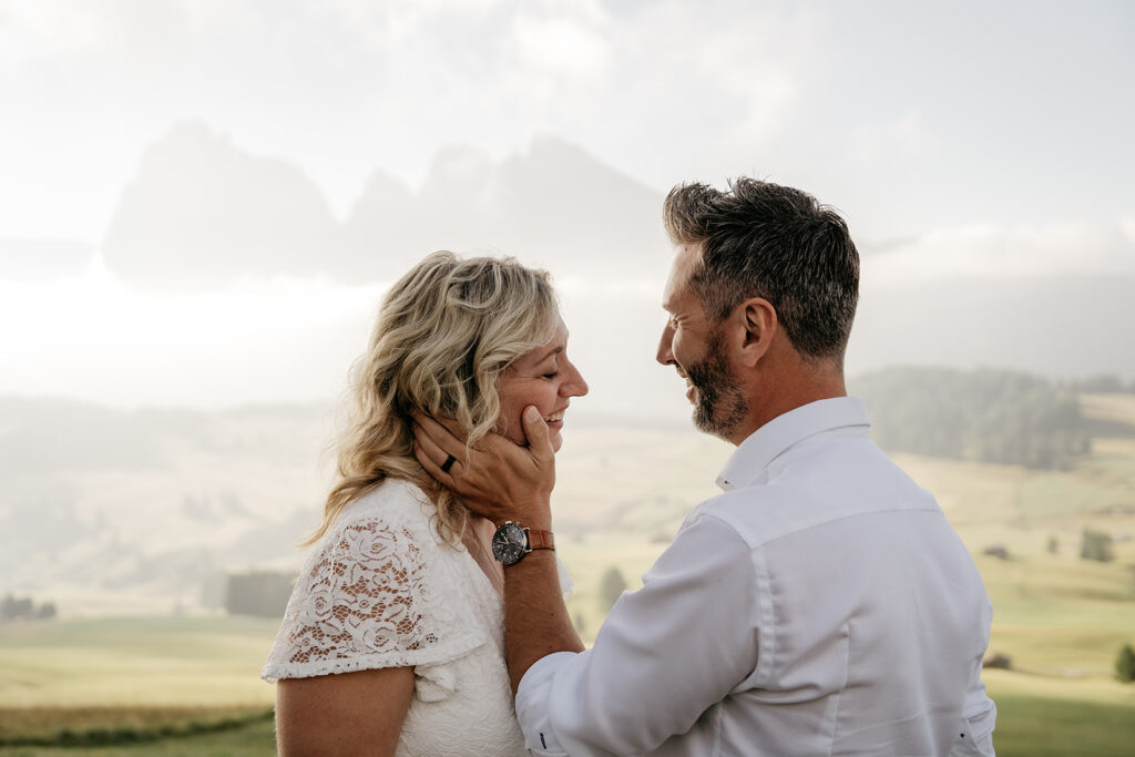 Couple embracing outdoors with scenic background