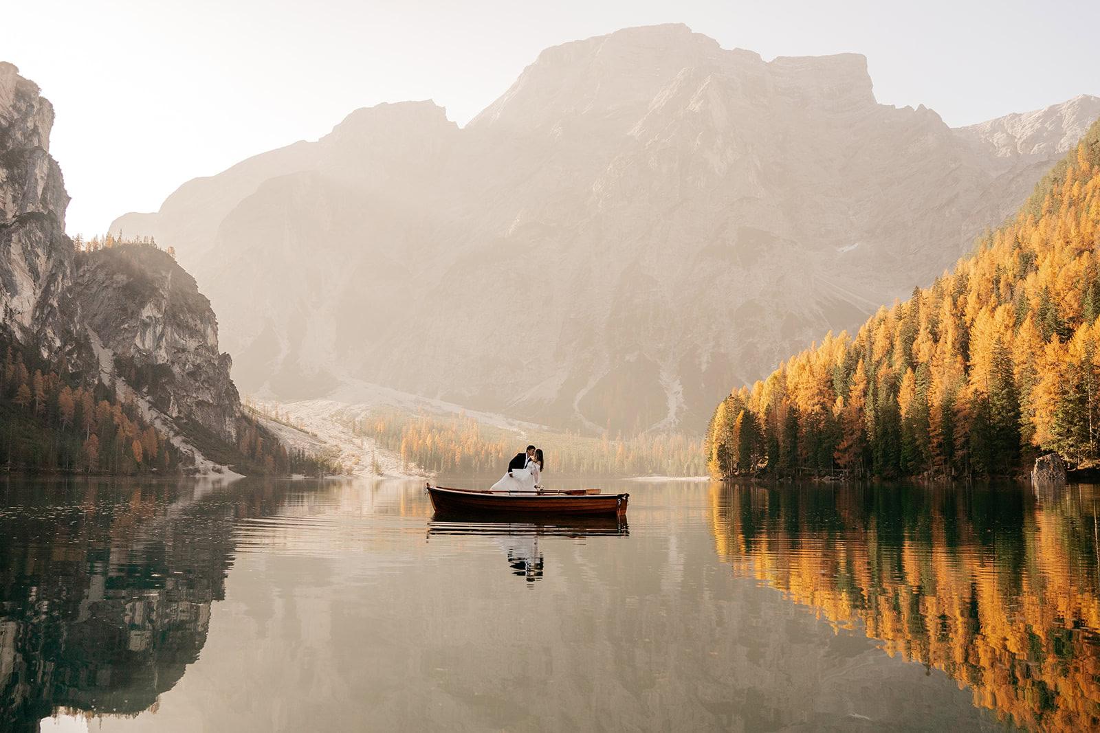 Couple in boat on mountain lake.