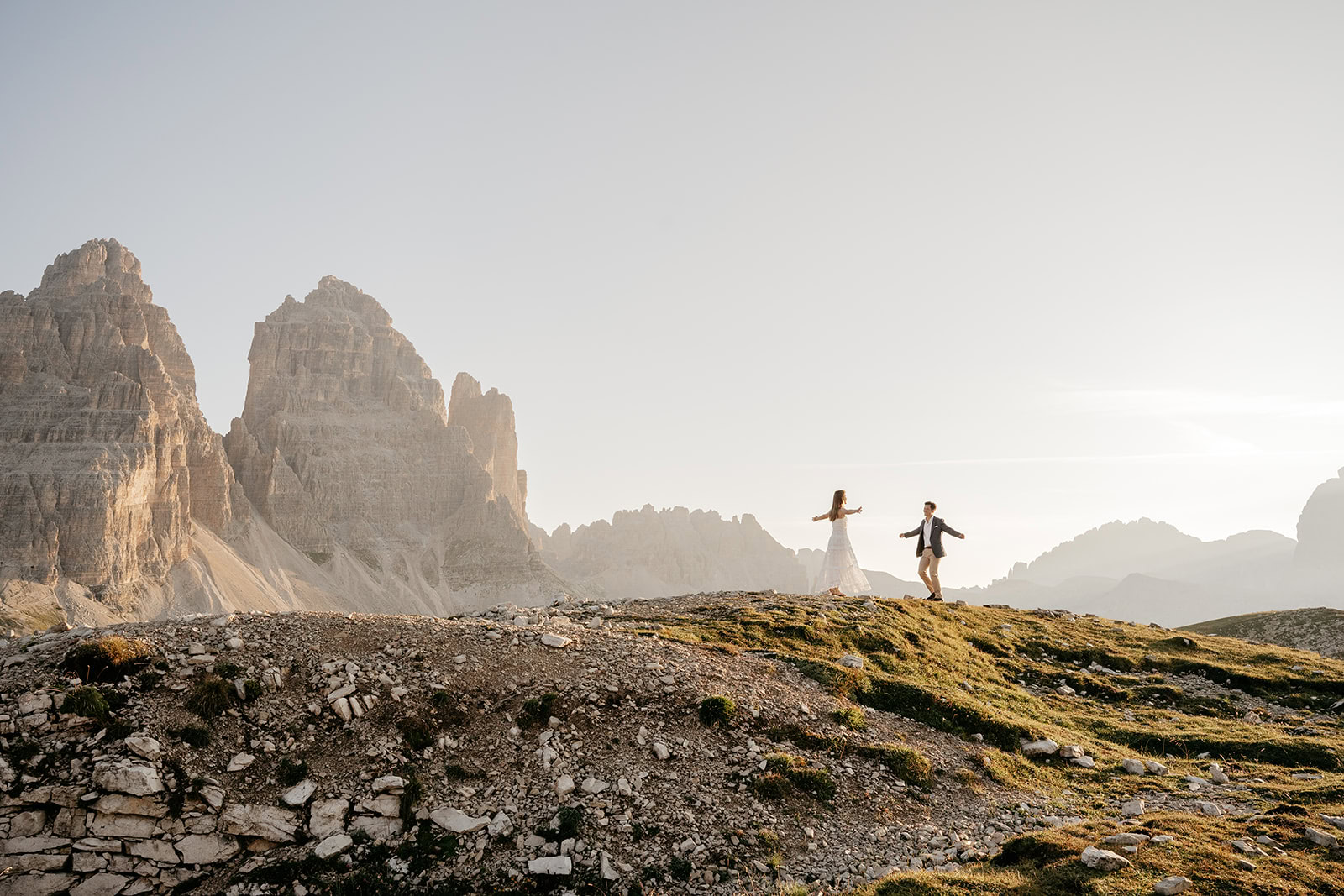 Couple dancing on mountain with scenic backdrop