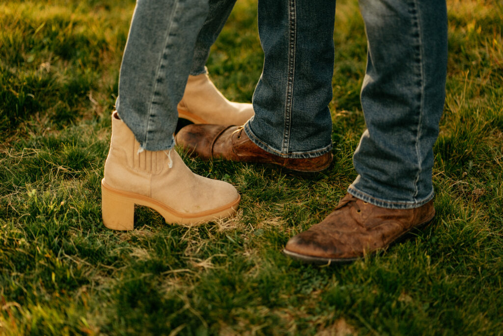 Close-up of couple's shoes on grass