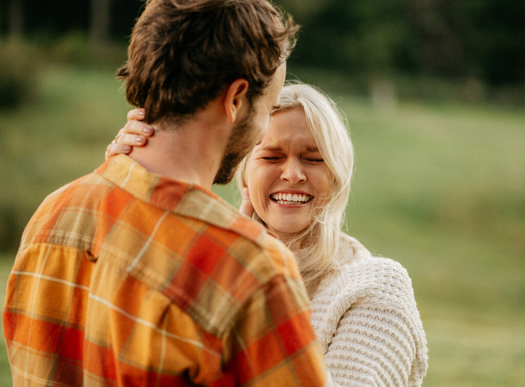 Couple smiling outdoors in nature setting