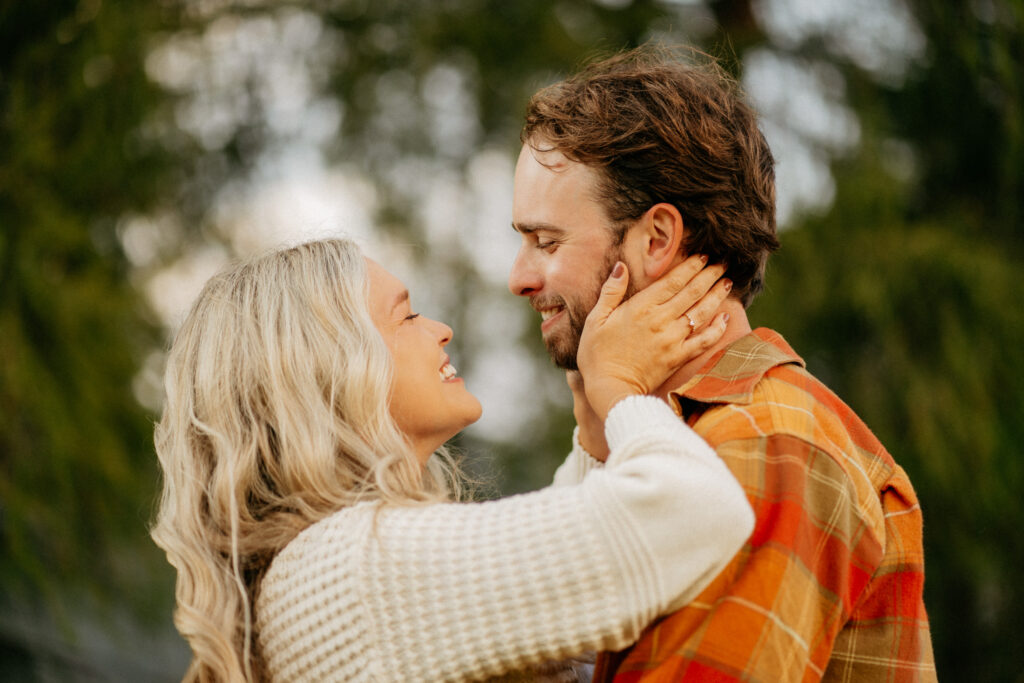 Couple smiling at each other outdoors