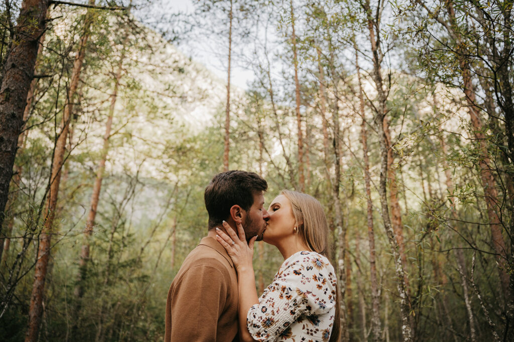 Couple kissing in forest setting