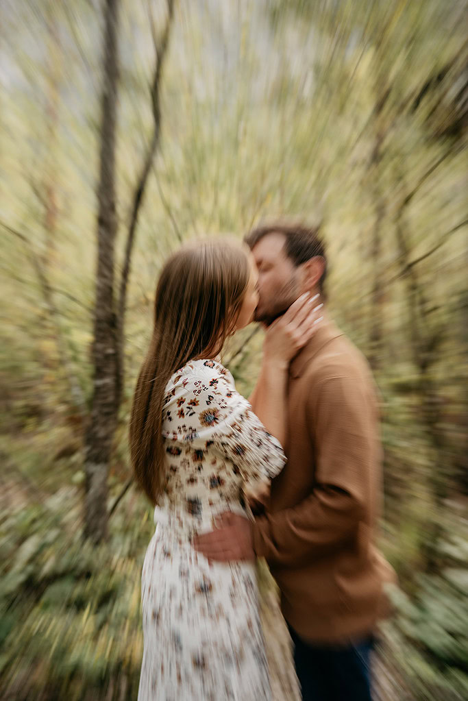 Couple kissing in a blurred nature setting