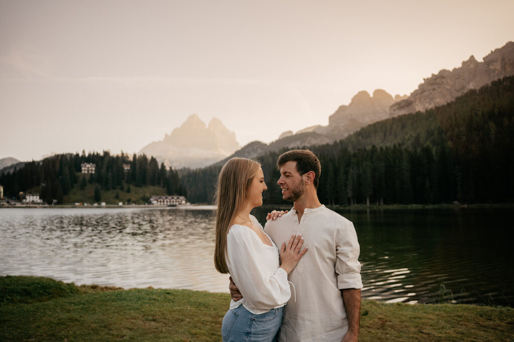 Couple by mountain lake at sunset