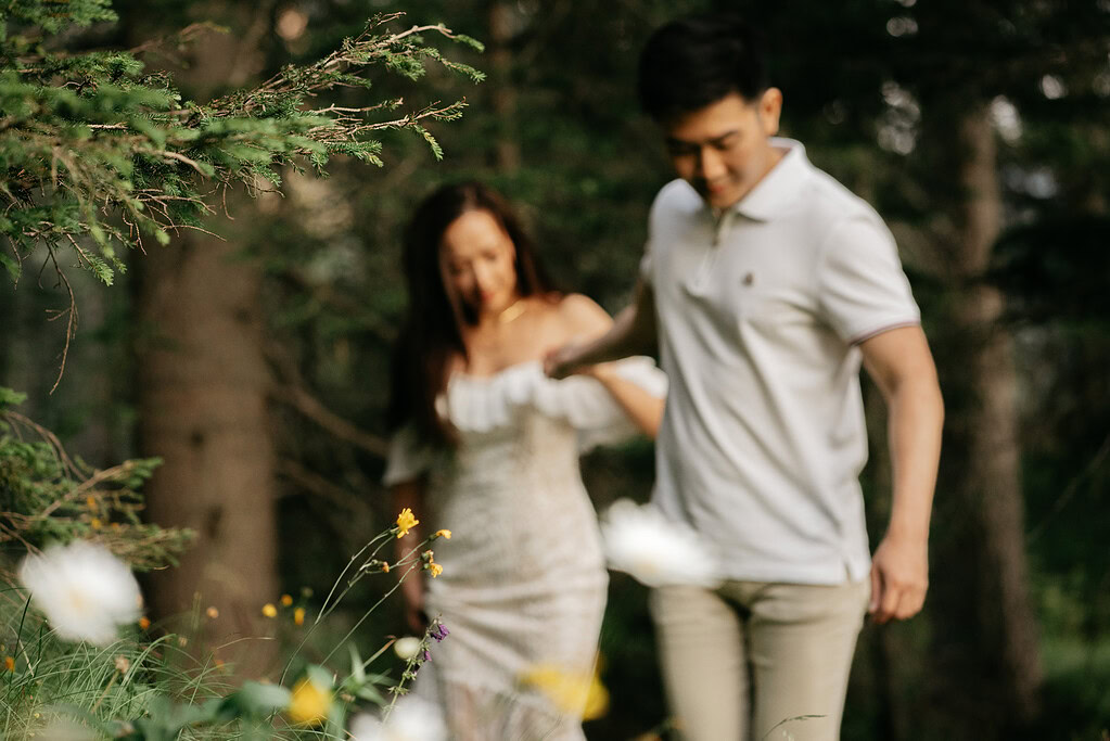 Couple walking through a forest.