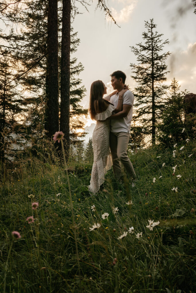 Couple embracing in forest at sunset