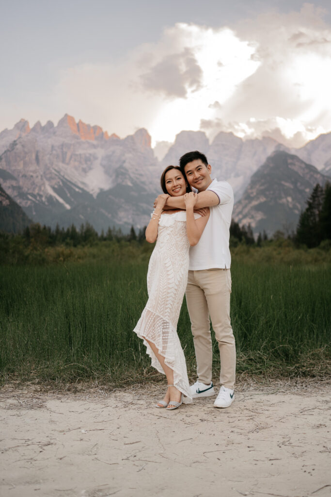 Couple embracing in mountain landscape.