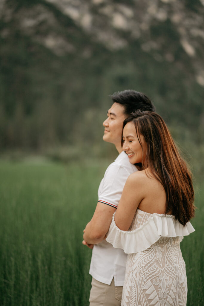 Couple hugging outdoors in nature.