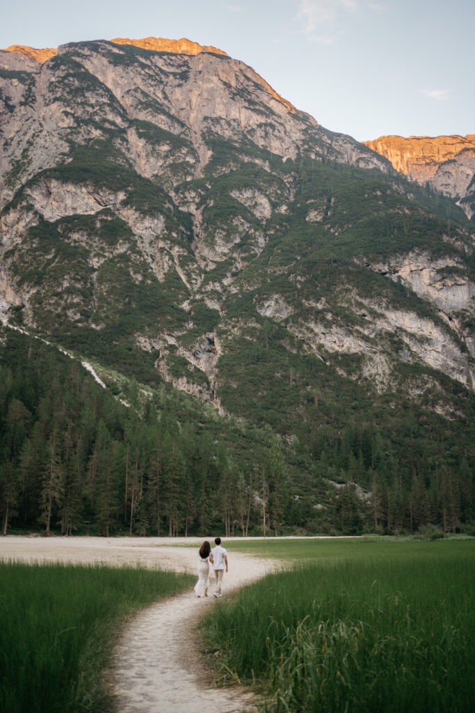 Couple walking on path, mountain background