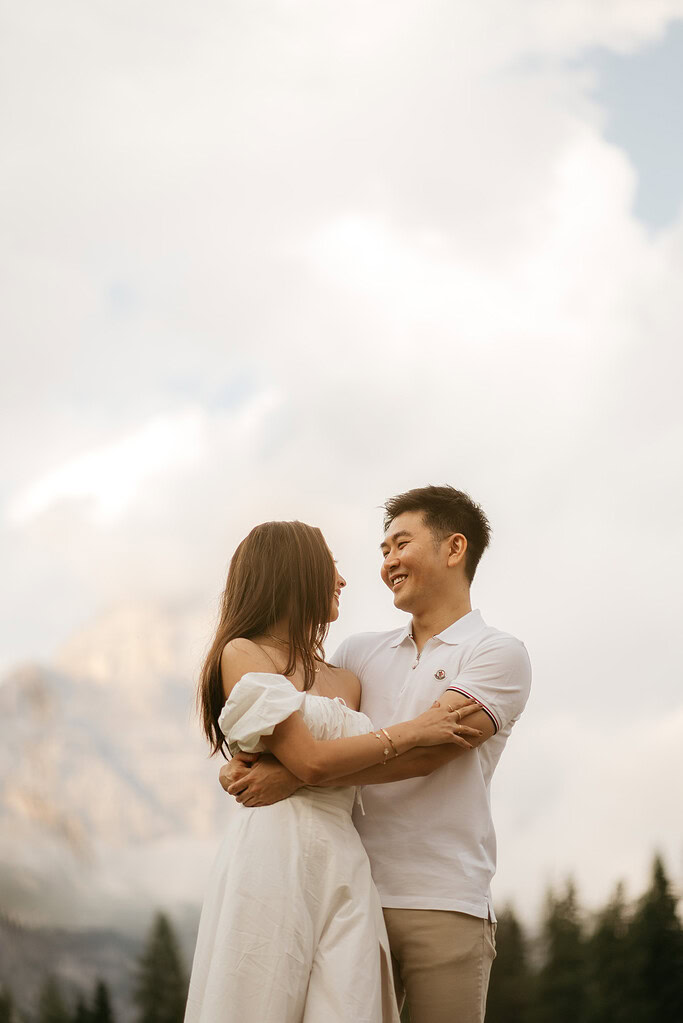 Couple sharing a romantic embrace outdoors.