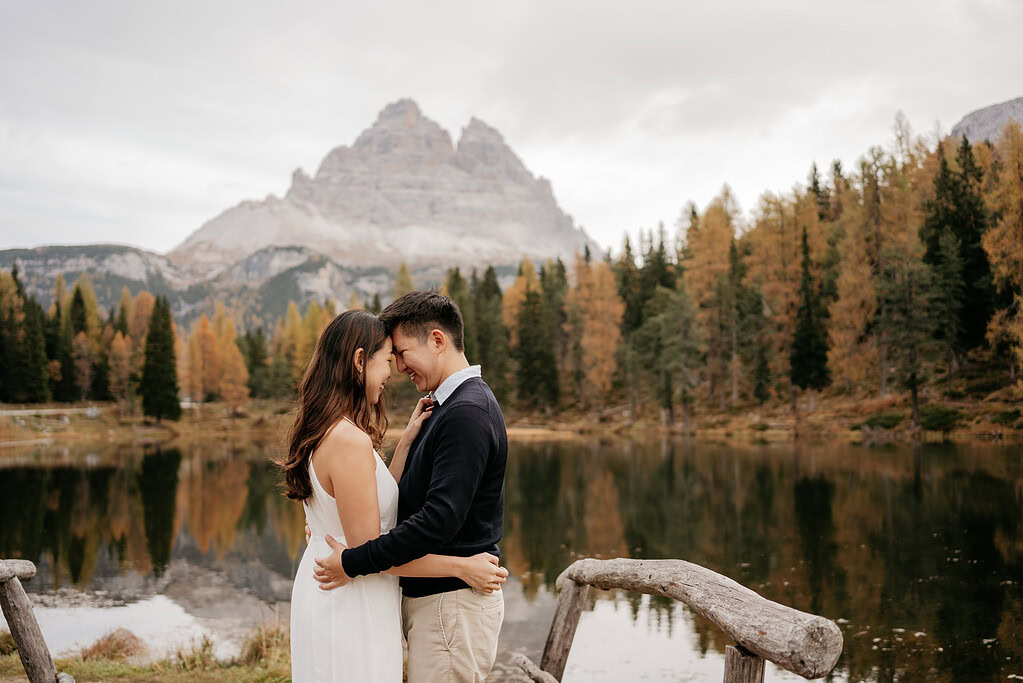 Couple embracing near mountain lake in autumn