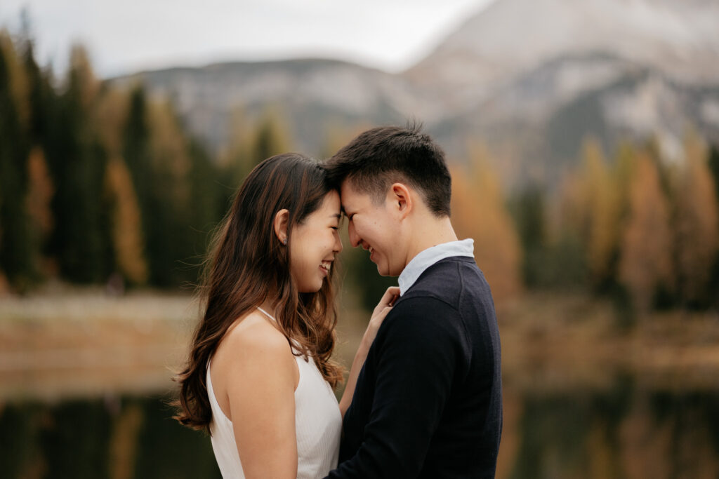 Couple smiling in nature with mountains background