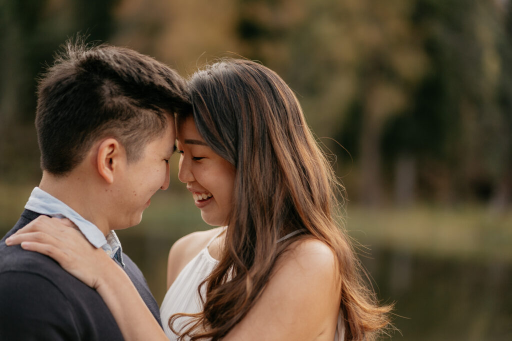 Couple smiling and embracing outdoors.