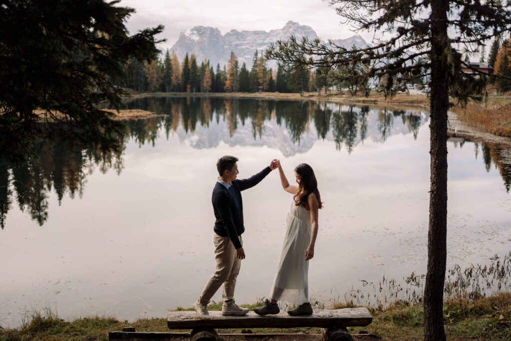 Couple dancing by scenic lake and mountains