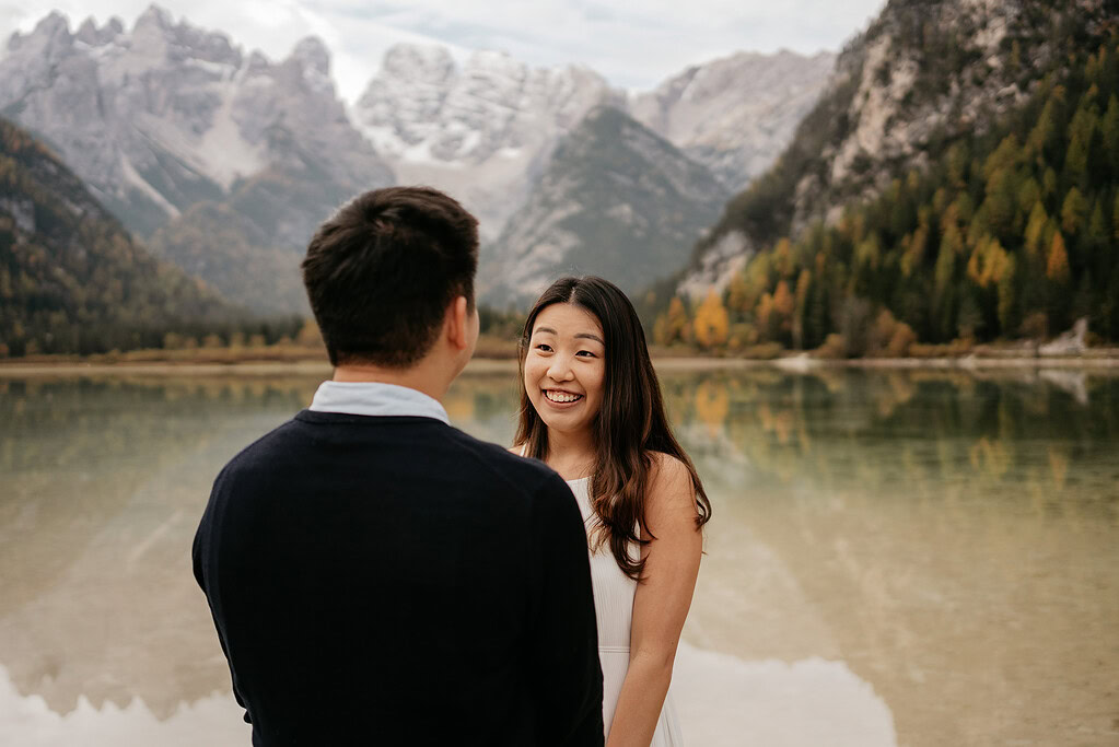 Couple smiling by scenic mountain lake