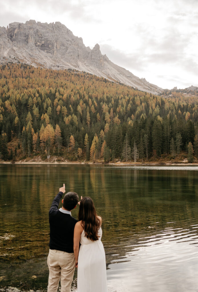 Couple pointing at mountain across lake