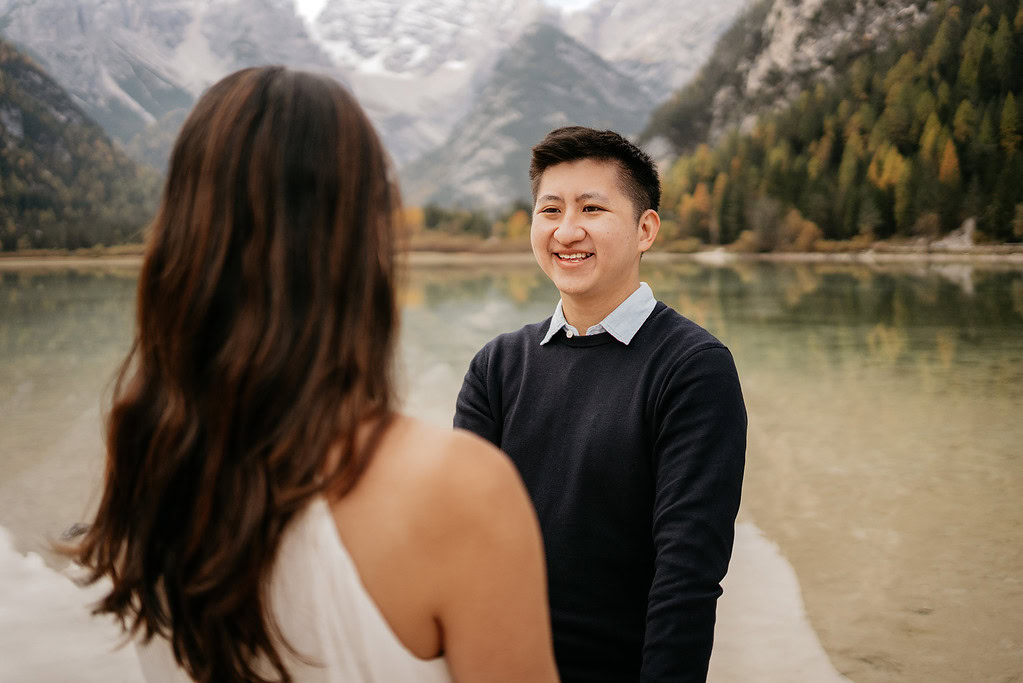 Smiling couple near serene mountain lake