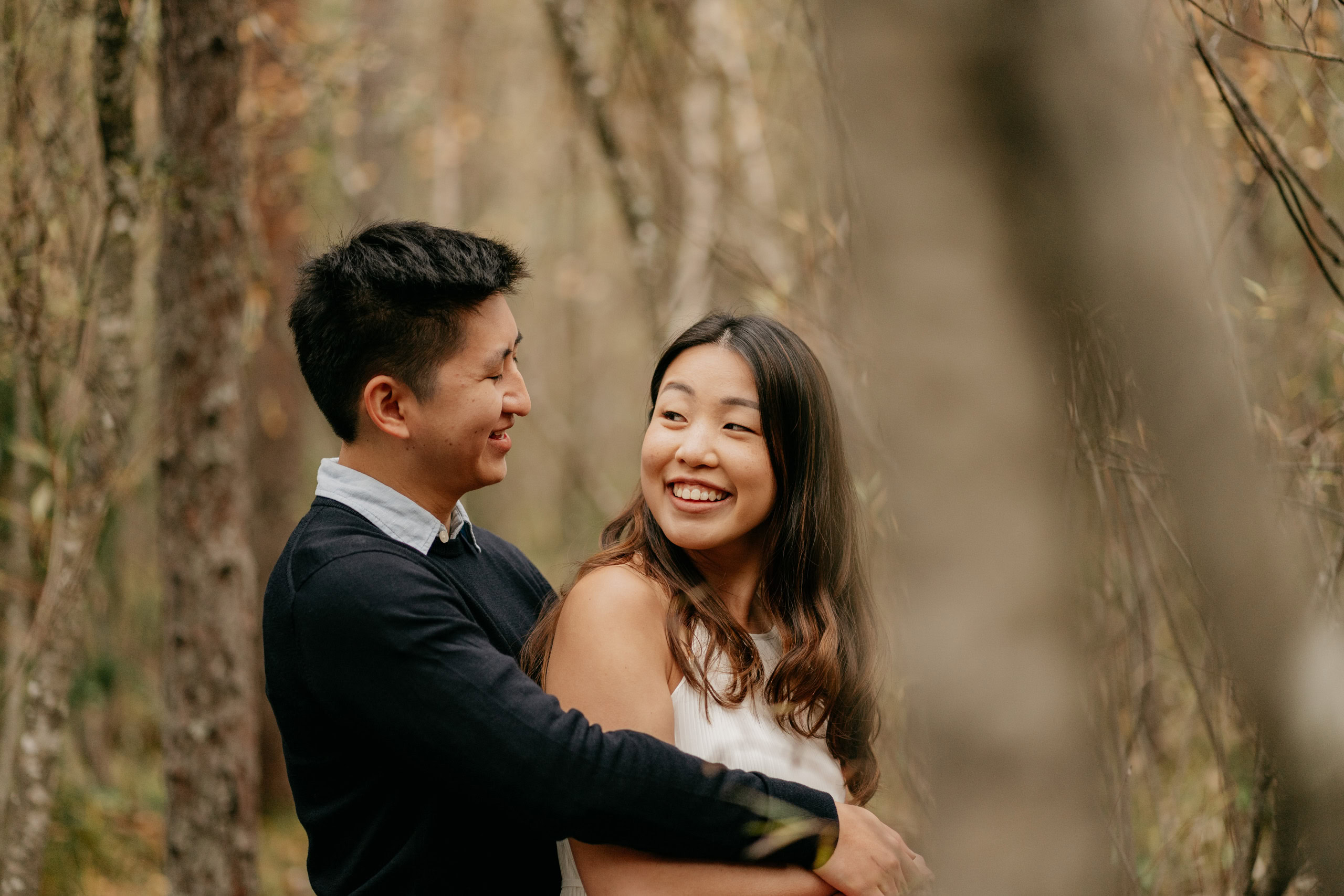 Couple smiling in a forest setting