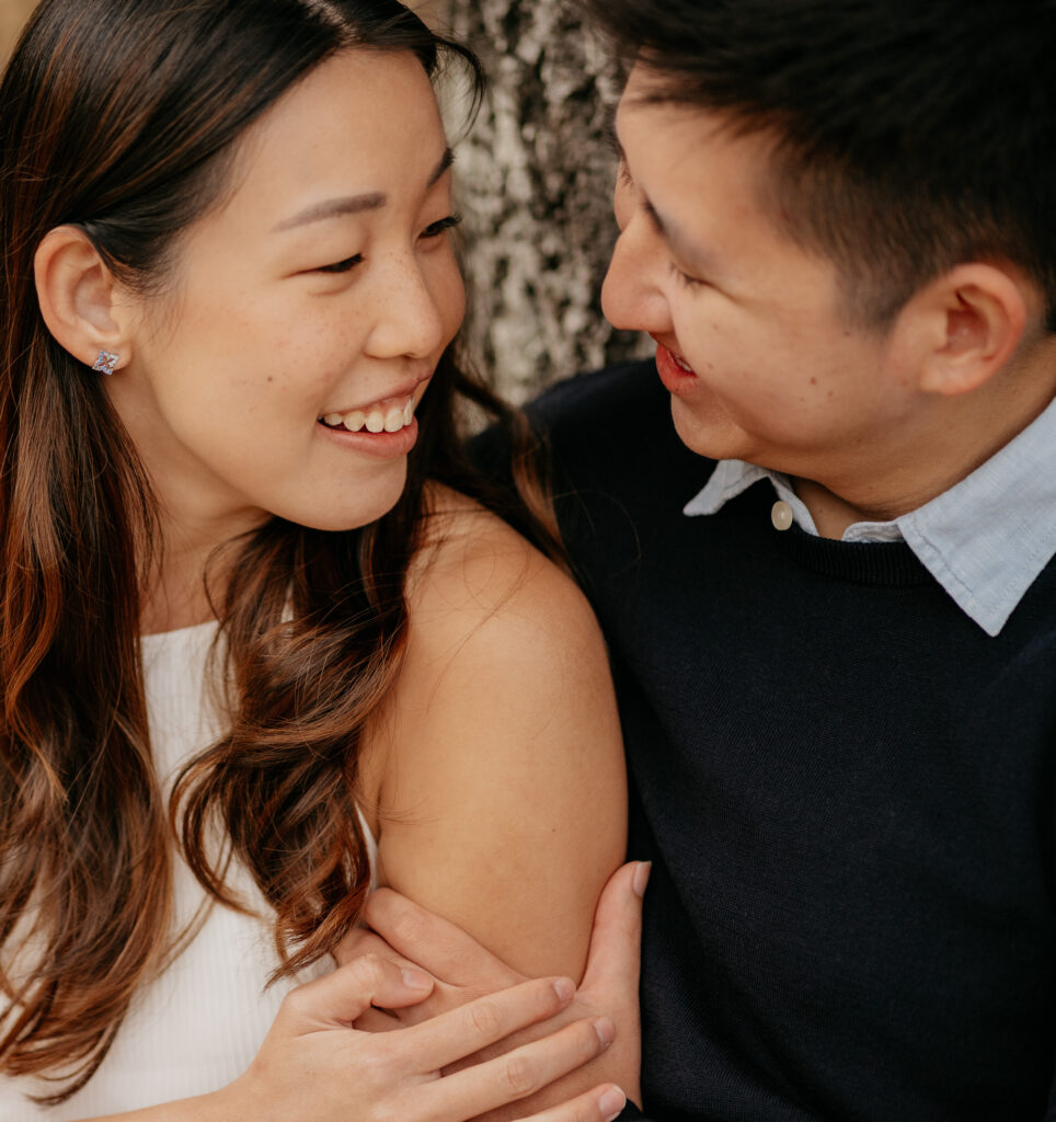 Smiling couple embracing outdoors.