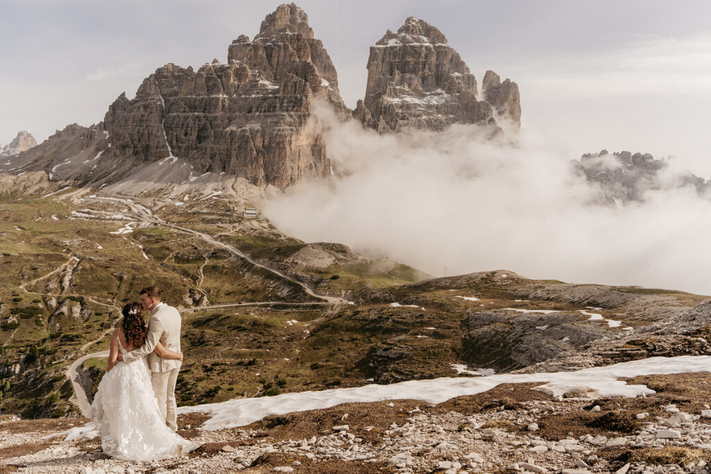 Wedding couple in front of mountain landscape.