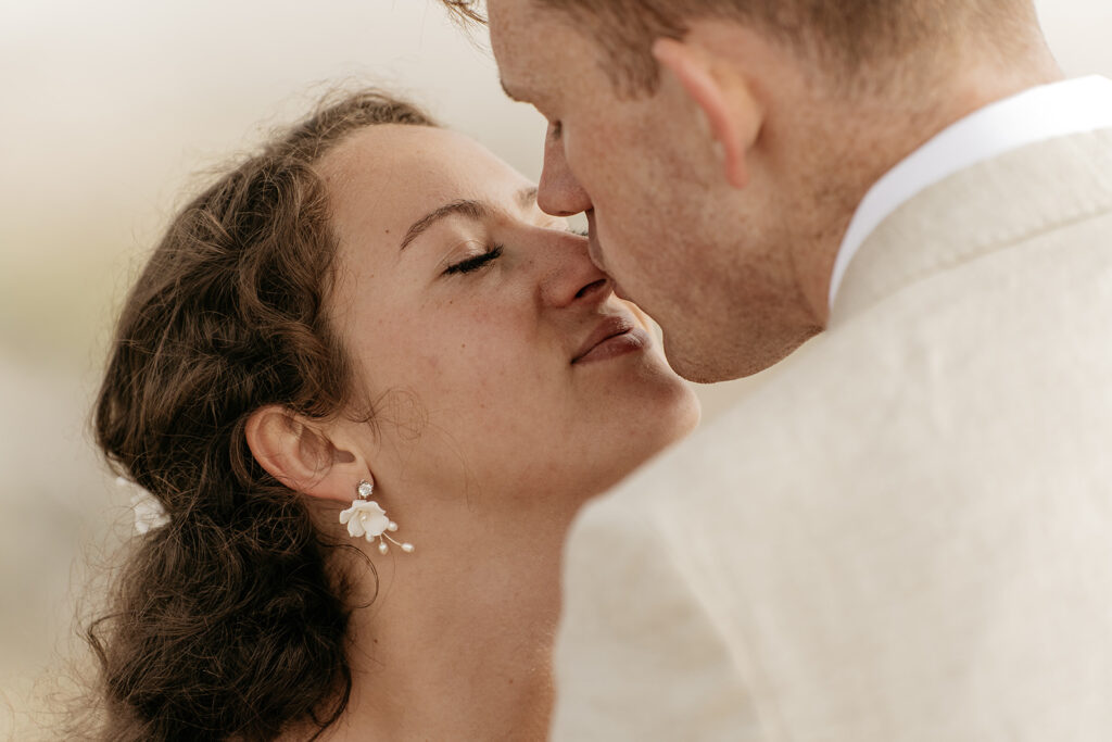 Couple kissing at wedding celebration.