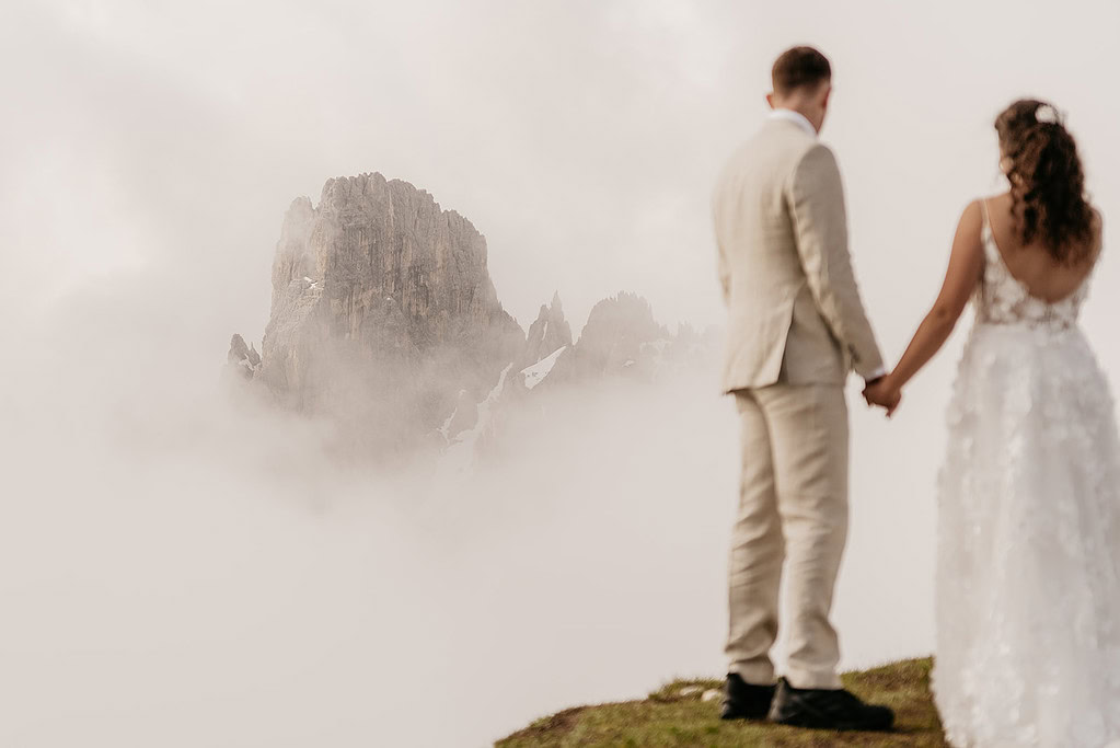 Couple holding hands with mountain view