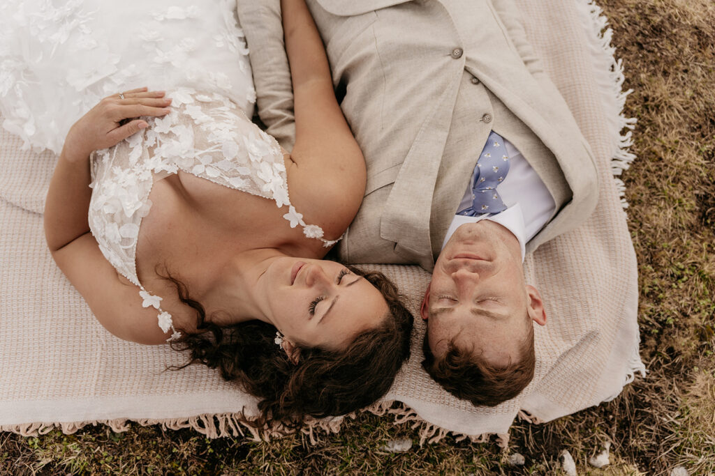 Couple lying on blanket outdoors