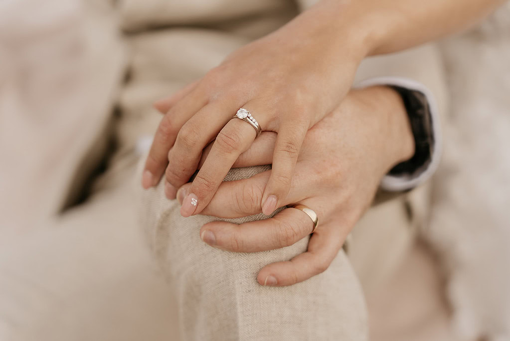 Couple's hands with wedding rings