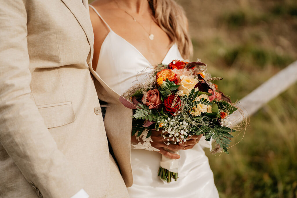 Bride holding colorful wedding bouquet