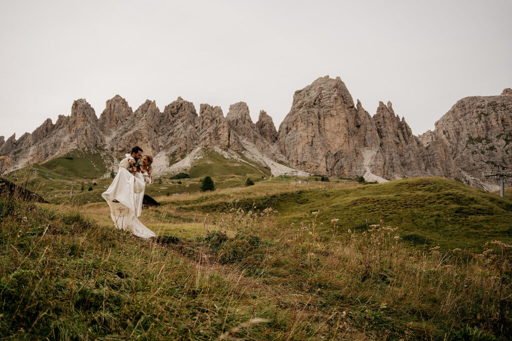 Couple in wedding attire in mountain landscape