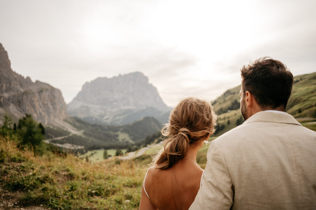 Couple admiring mountain landscape at sunset