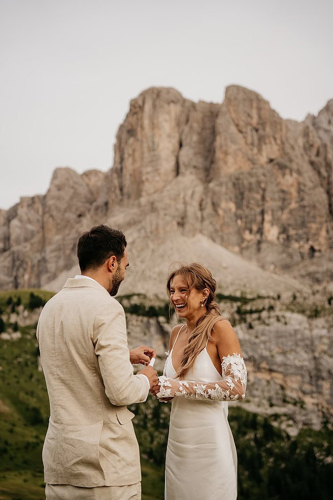 Couple exchanging vows in mountain setting.