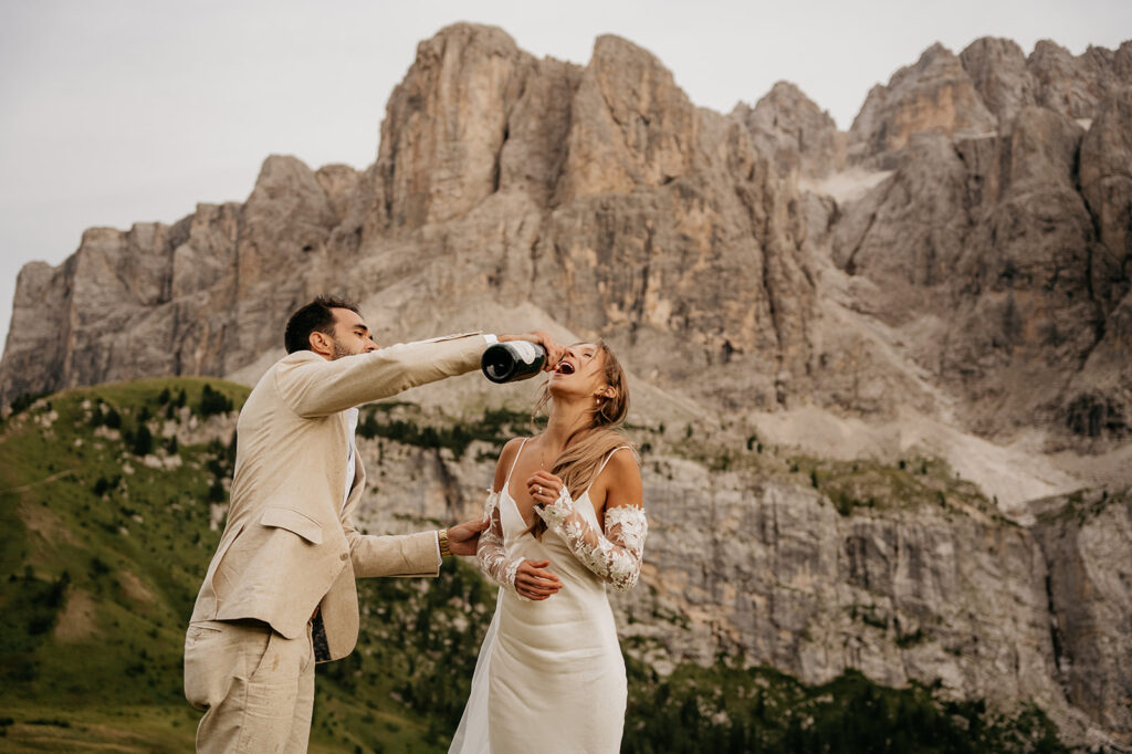 Couple celebrating with champagne in mountain landscape