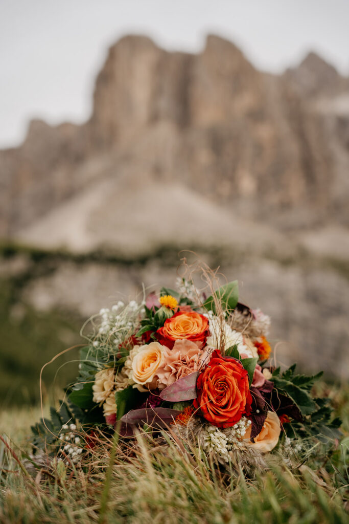 Colorful flower bouquet in front of rocky background.