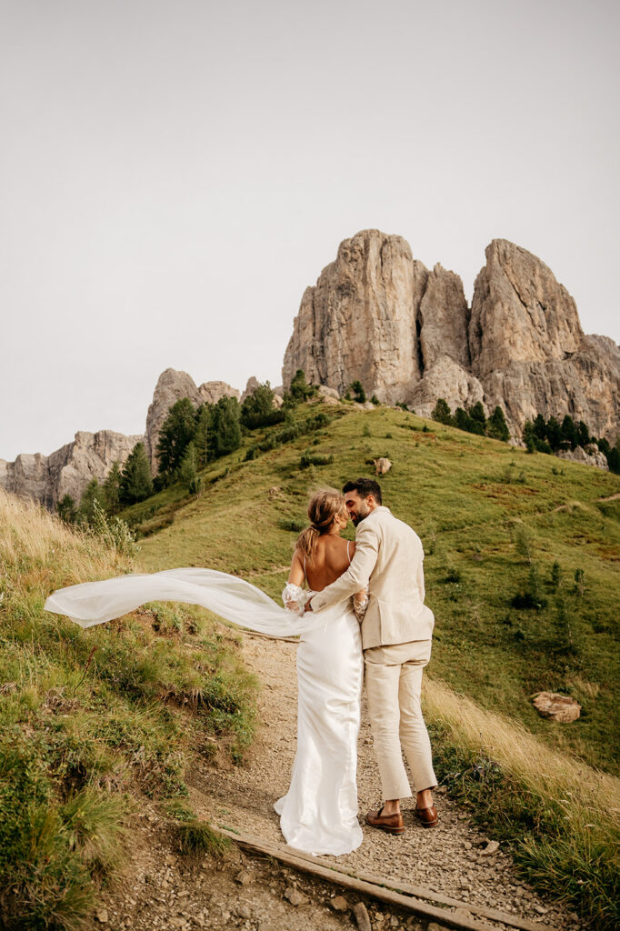 Bride and groom on scenic mountain path