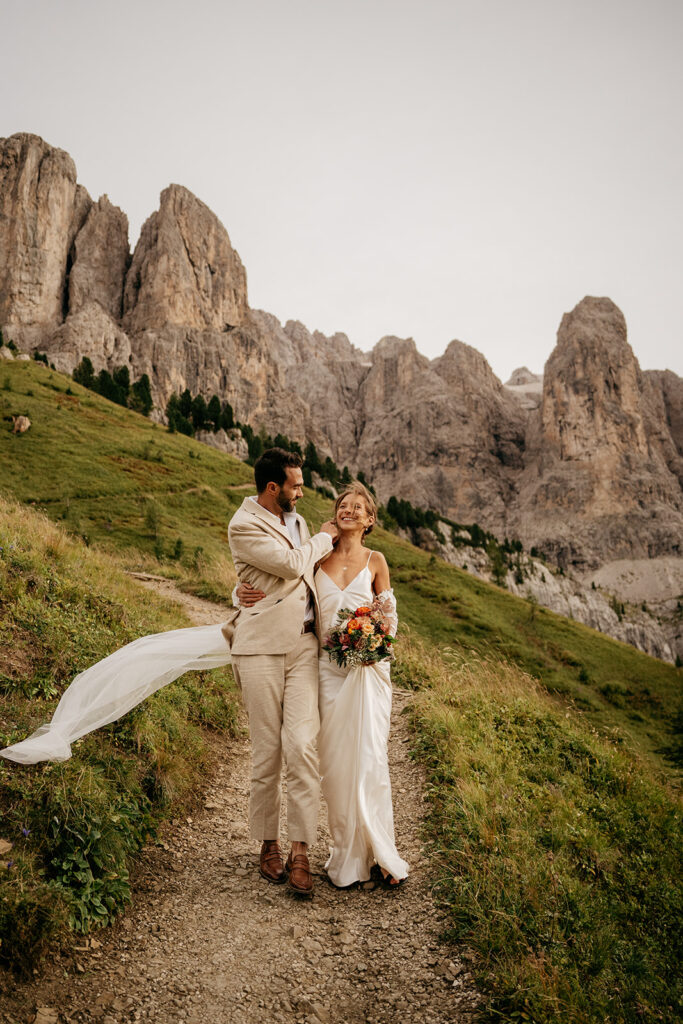 Couple in wedding attire, mountain background