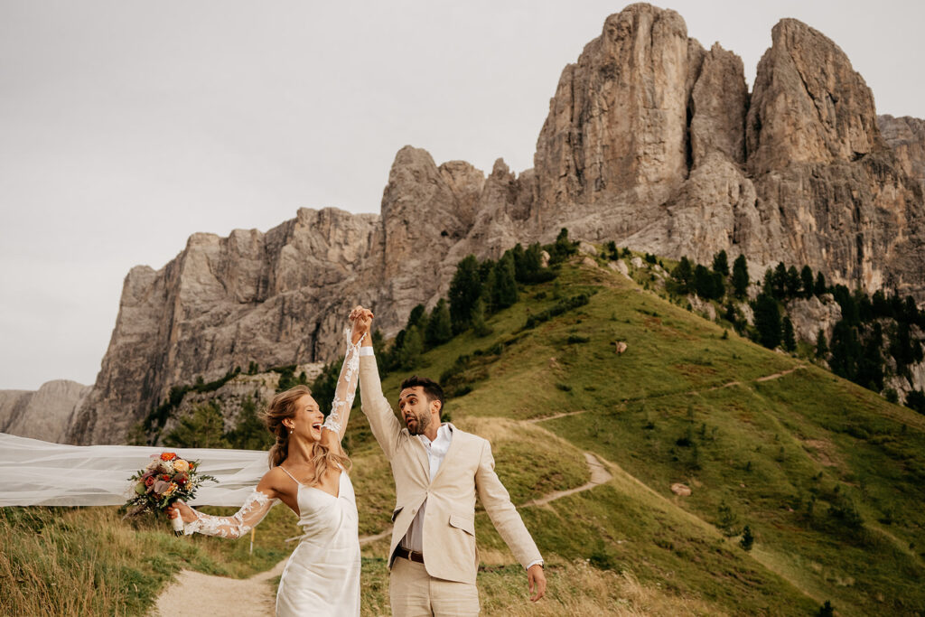 Bride and groom celebrating in mountains