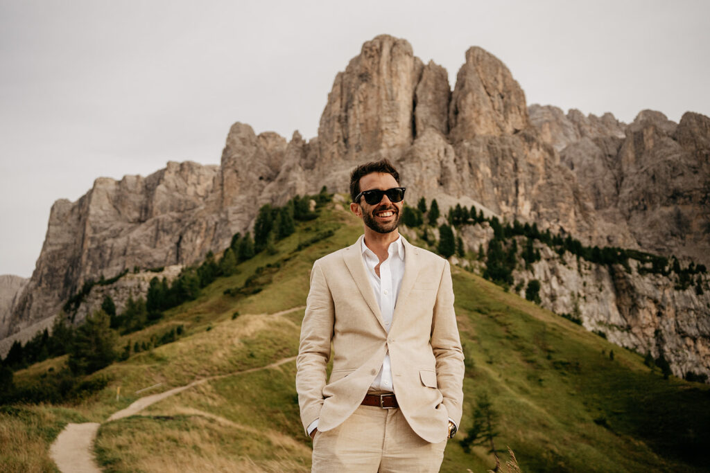 Smiling man in suit, mountain backdrop