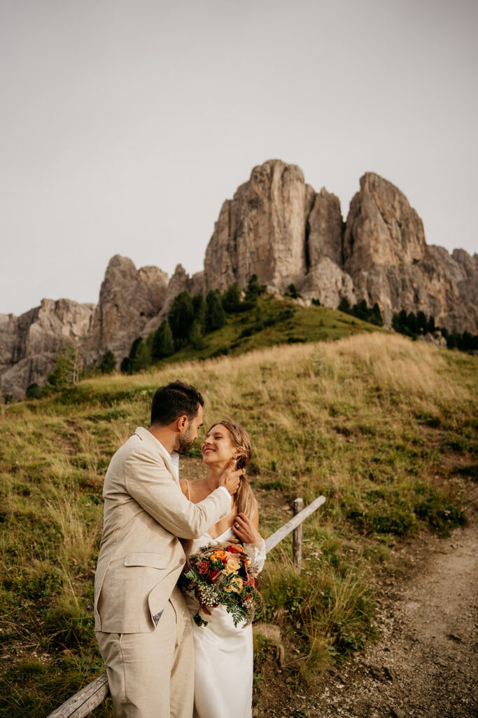 Couple embraces at scenic mountain wedding.