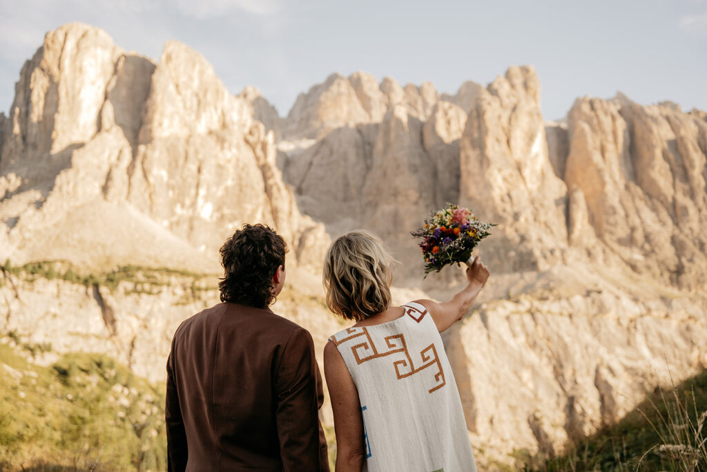 Couple celebrating with mountains in the background.