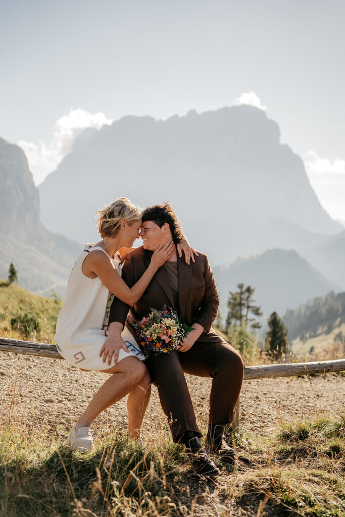 Couple sharing romantic moment in mountain landscape.