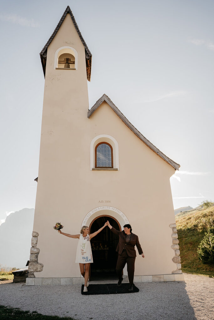 Couple dancing in front of picturesque church