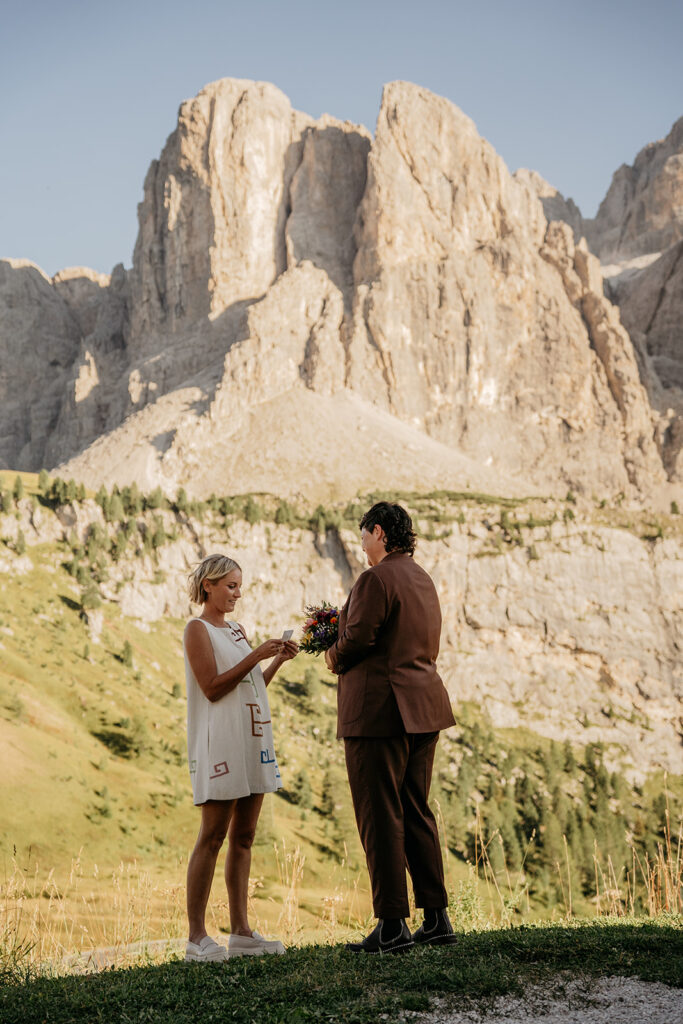 Couple exchanges vows in mountain landscape wedding.