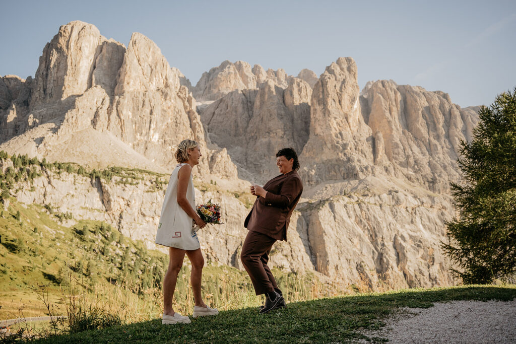 Couple laughing at mountain backdrop wedding ceremony.