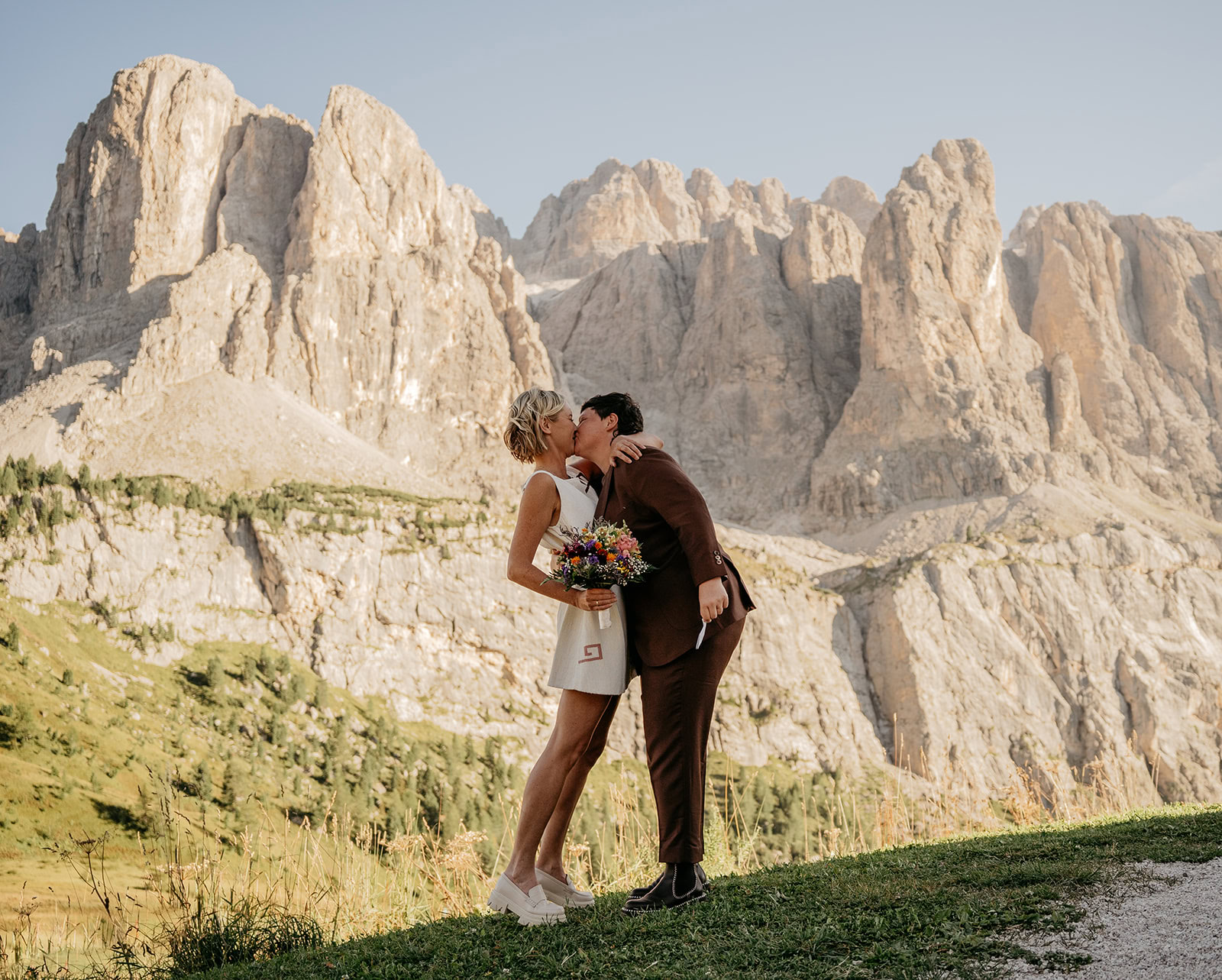 Couple kissing in front of mountain scenery