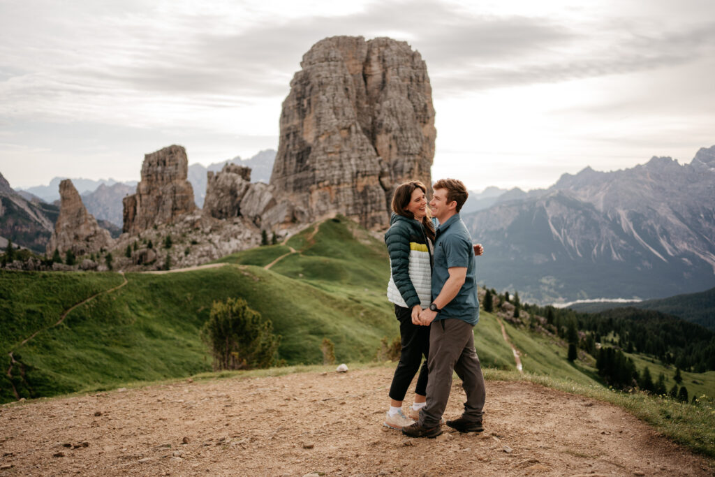 Couple embracing in mountains with tall rock formations