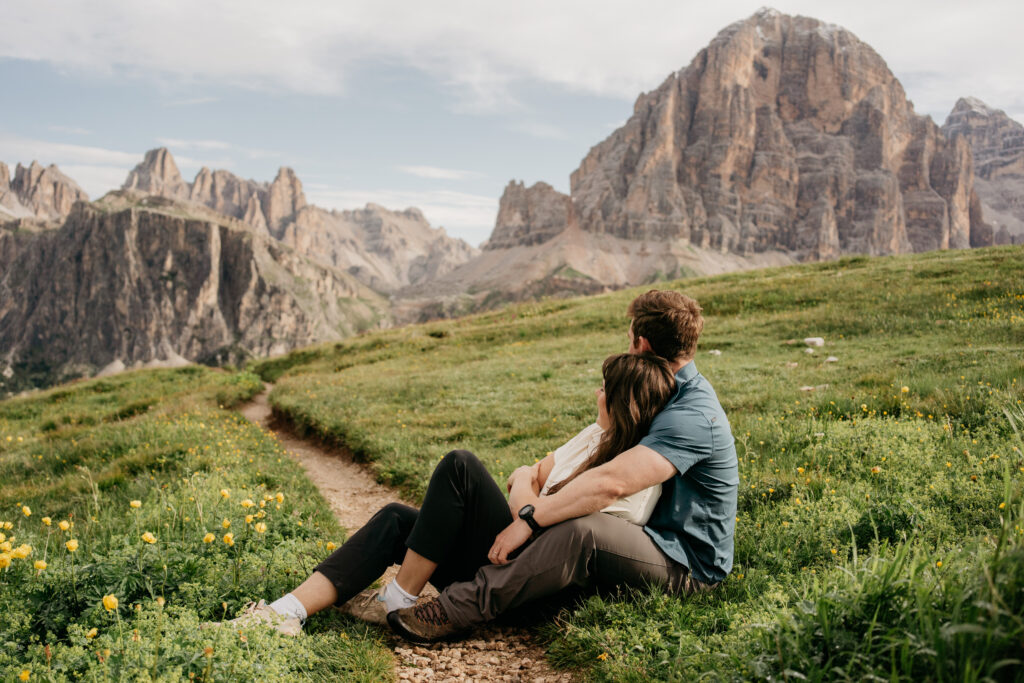 Couple sitting on grassy mountain path